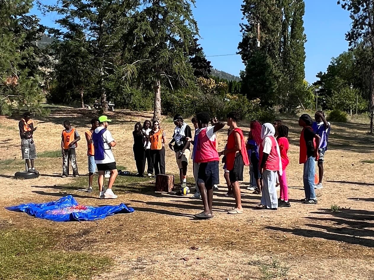 Youth gathered together at a community camp